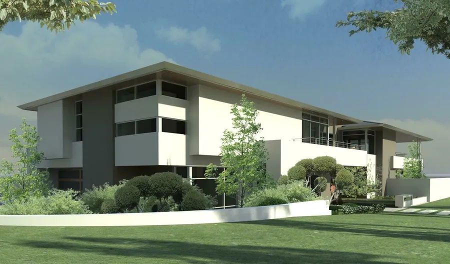 Side elevation showing the floating roofline and the stone feature wall along the garage side.