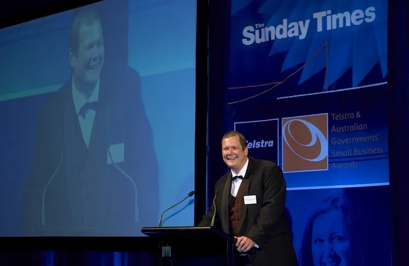 Nathan Buzza at the Telstra & Australian Government Small Business Awards podium, 2005.